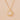 Gold necklace with a face pendant on a beige background