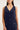 Navy sleeveless dress with buttons on a plain background