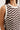Brown and white zigzag patterned sleeveless top worn by a person.