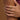Close-up of a hand wearing gold rings with a blurred background