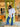 Woman wearing a white shirt and blue jeans standing in front of a store entrance.