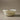 White ceramic bowl with brownish glaze on a beige background