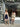Two women posing in front of a store with floral decorations.