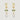 Gold earrings with green gemstones and pearl-like beads on a light gray background