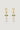 Gold earrings with green gemstones and pearl-like beads on a light gray background