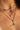Close-up of Toni May layered necklaces on a person's neck