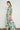 Side angle view of the Admire Dress in garden paisley highlighting short gathered sleeves and natural movement in the skirt.