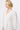 Close-up of the Alicia Shirt in White showing the V-neckline with delicate lace framing and floral embroidered 3/4 sleeves.