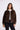 Woman wearing a leopard print jacket on a white background