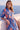 Amalia Valencia Dress crafted from 100% hemp featuring a vibrant blue and red floral print shown in an upper body lifestyle view.