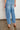 Ascend Pant - Mid Wash Denim back view featuring back patch pockets, a relaxed casual fit, and ankle length in mid wash denim.