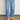 Ascend Pant Mid Wash Denim front view featuring a high-rise silhouette, elasticated drawcord waistband, and front patch pockets in mid wash denim.