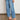 Ascend Pant Mid Wash Denim waistband detail showcasing the drawcord adjustable waistband and cotton-lyocell denim fabric.