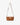 Aurora Bag in tan leather styled with an adjustable long crossbody strap and light gold hardware.