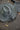 Aziz Lace Hat handwoven from natural raffia fibers featuring a sun-shielding brim and cross-stitched leather cord in light grey.