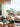 Beach House book interior capturing an outdoor dining setup with fresh food overlooking a scenic coastal mountain view.