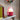 Berry Portable LED Ole Lamp styled on a grey side table indoors, featuring a dark red base and a glowing white dome shade.