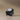 Black ceramic sculpture on a beige background