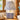 Blue Stripe Lamp with stripe shade placed on a wooden surface near a window.