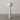 Full view of the Boucle Floor Lamp featuring a sculptural, layered design and tapered base wrapped in neutral boucle fabric.