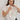 Carrie Zip Top knitted from 100% Pima cotton in an open stitch featuring a half-zip funnel neck and relaxed fit in cream shown in an upper body view.