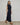 Casey Fringe Skirt knitted from 100% Pima cotton featuring an elongated silhouette and fringe detailing in navy shown in a side walking view.