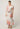 Model showcasing the Cattleya linen maxi dress in Nautilus Bloom print with button accents and hidden hip pockets.
