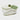 Cherie ceramic smoked pistachio scented candle in a white porcelain vessel with green hand-painted details and a matching lid with a green handle.