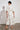 Clarity Dress Painterly Bloom crafted in 100% linen featuring a high mandarin collar and tiered skirt shown in a back view.
