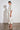 Clarity Dress Painterly Bloom crafted in 100% linen featuring a high mandarin collar and tiered skirt shown in a side view.