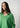 Model wearing the classic V-neck sweater in green featuring a V-neckline and soft knit texture.
