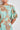 Close-up detail of the Coast Dress in mint kgari showing the round neckline and pleated balloon sleeve.