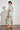 Coast Dress in mint kgari side profile view showing the midi silhouette and linen drape.