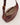 Open top view of the Crescent Sling showing secure double zip closure, durable herringbone cotton lining, and an internal zipper pocket in warm maple waxy leather.