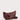 Crescent Sling in warm maple waxy leather featuring a spacious silhouette, clean lines, double zip closure, and antique brass-toned hardware.