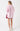 Darby Shirt Berry Stripe shown from the back, featuring a longline curved hemline and relaxed oversized cotton fit.