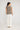 Darcia monochrome knit top featuring a stripe cotton knit construction and hip-length cut viewed from the back.