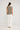 Darcia monochrome knit top featuring a regular fit and side splits viewed from the back on a model.