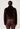 Person wearing a dark brown fur and brown pants on a white background