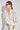 Depart Top in elm side view showing the relaxed fit and polyester lace texture.
