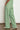 Back view of the Driftline Pant in Apple green, highlighting the high-rise straight-leg profile, full length, and clean tailoring.