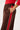 Brown pants with a red stripe worn by a person on a white background