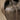 Close-up view of the deeply fissured, earth-toned surface evoking volcanic rock and ancient bark.