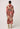 Person wearing a long, patterned 
Once Was dress with a belt on a white background
