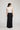 Edris Skirt in black featuring a regular fit and satin construction viewed from the back.