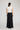 Edris Skirt in black featuring a maxi length silhouette viewed from the back.
