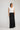 Edris Skirt in black featuring a classic A-line shape and fluted hem worn by a model.