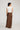 Edris Skirt in chocolate featuring a regular fit and satin fabric viewed from the back.