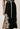Elodie One Shoulder Embroidery Dress Black side split detail view showcasing the contrast ivory embroidery along the split.