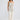 Full-length front view of a model wearing the Elsbeth Top in Ivory Spot paired with cream wide-leg trousers.